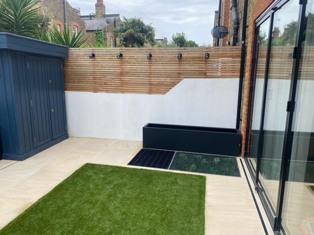 Quarrendon Street Fulham London SW6- New garden design including shed-trellis-stone work-bespoke planters and walking on sky light